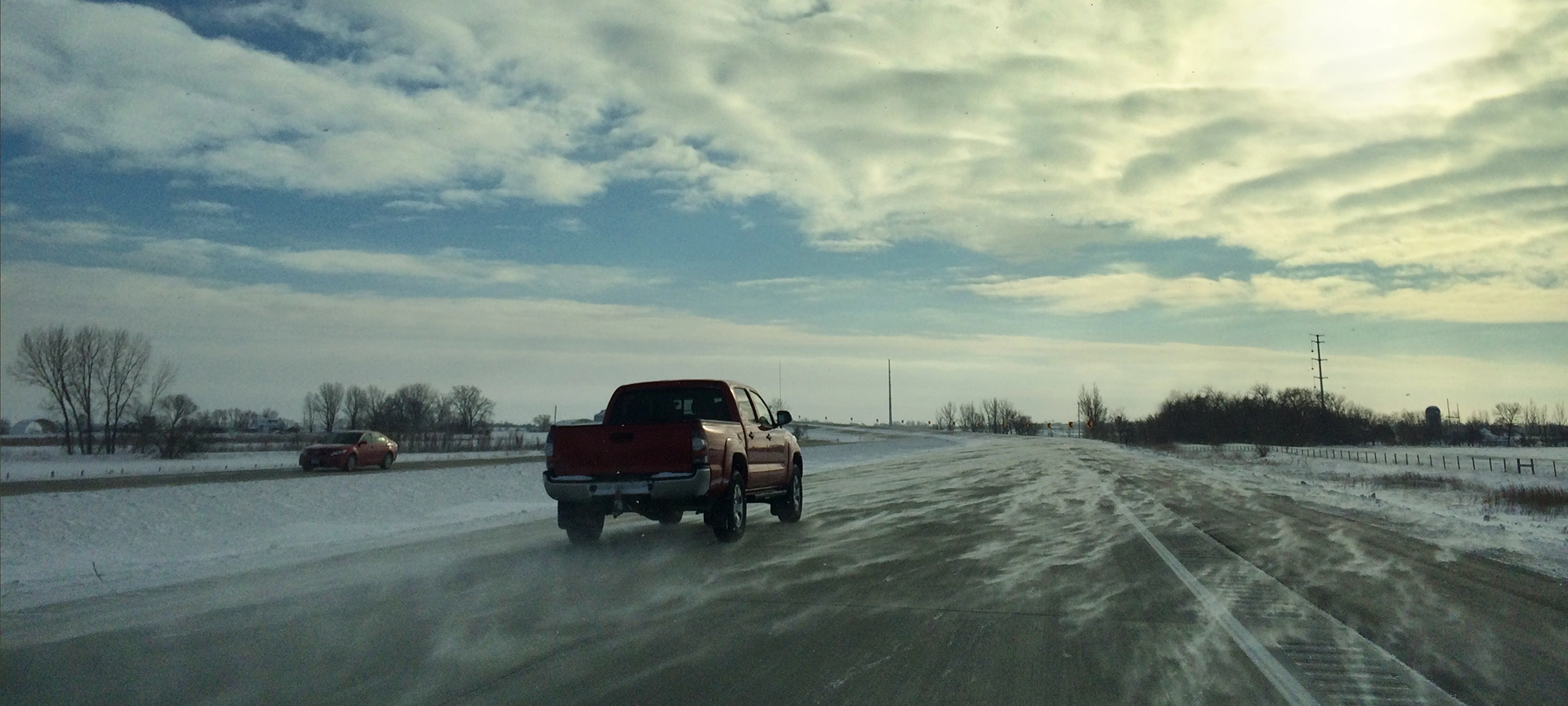 Truck driving on the interstate in rural Minnesota. Free Evaluation page.